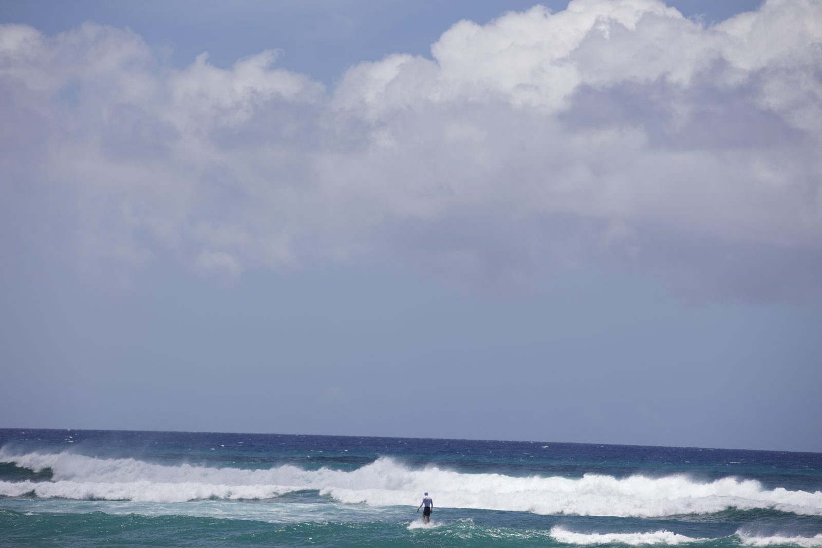 A surfer kicking out of a wave at Diamond Head, O'ahu